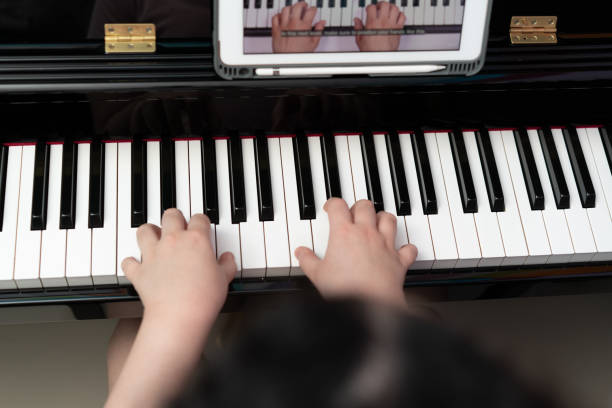 istock kid hands play piano key 1405186805