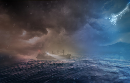 cargo ship sailing in heavy storm in a rough sea at night