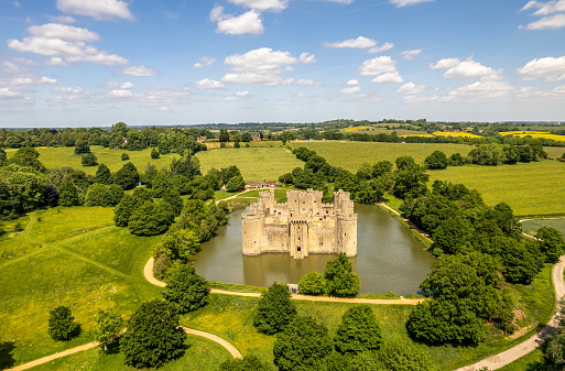 East Sussex, UK- May 27, 2022: The drone aerial view of Bodiam Castle. Bodiam Castle is a 14th-century moated castle near Robertsbridge in East Sussex, England.