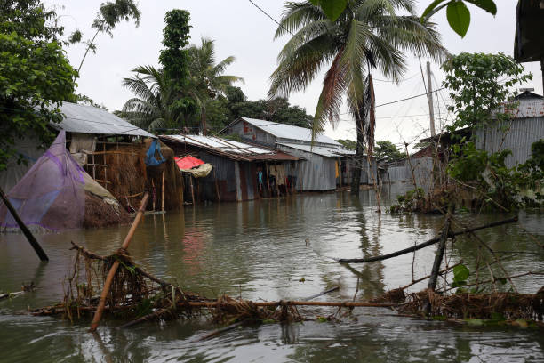 Houses in Sylhet submerged in floods Due to heavy rains, the lower part of Sylhet has turned into a flood. Houses submerged in flood waters. Photo taken from Sunamganj, Sylhet Division in Bangladesh on 18 June 2022. bangladesh stock pictures, royalty-free photos & images