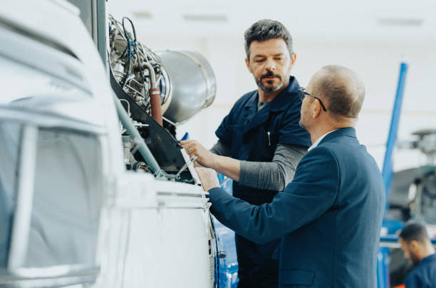 Aeronautical Engineer And Helicopter Owner Talking In Hangar