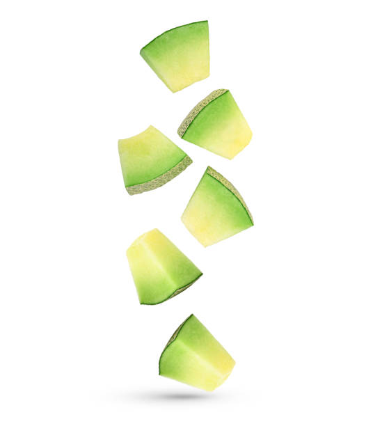 Falling slices of cantaloupe melon isolated on white