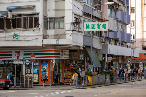 Hong Kong - June 26, 2022 : Pedestrians at the Fuk Lo Tsun Road and Prince Edward Road West in Kowloon City, Hong Kong.