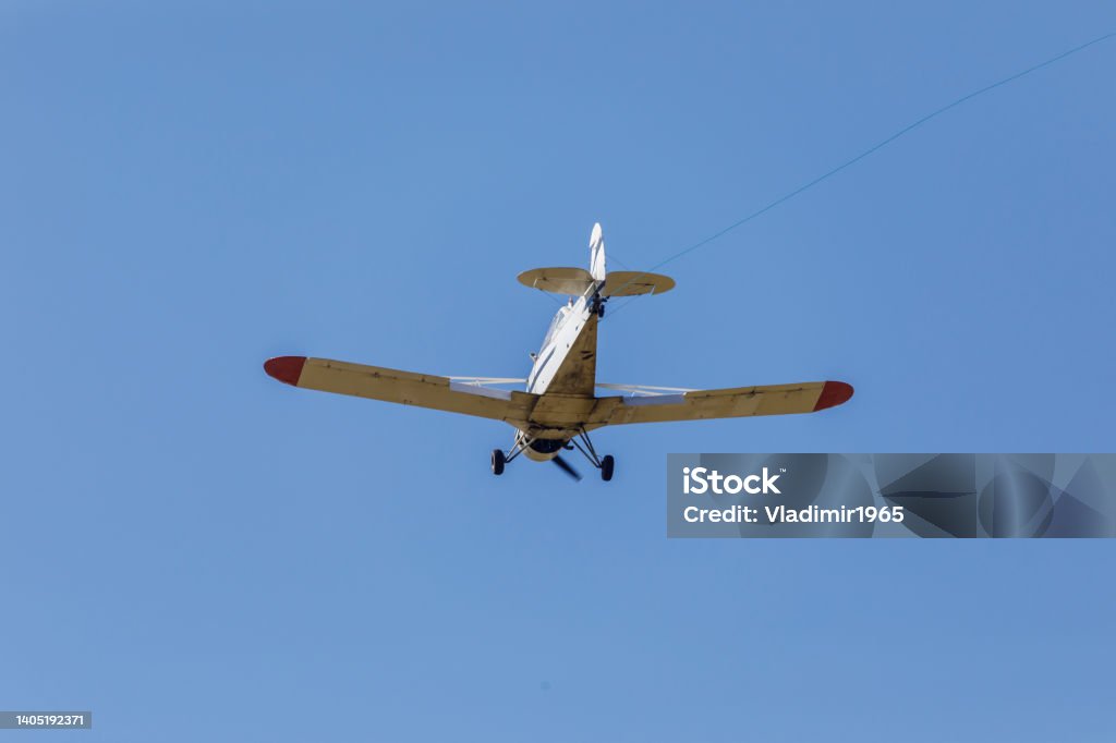Small flying aircraft Cessna Small flying plane Cessna with a towing cable Airplane Stock Photo