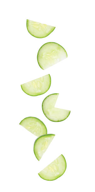 istock Sliced cucumber falling in the air isolated on white 1405192605