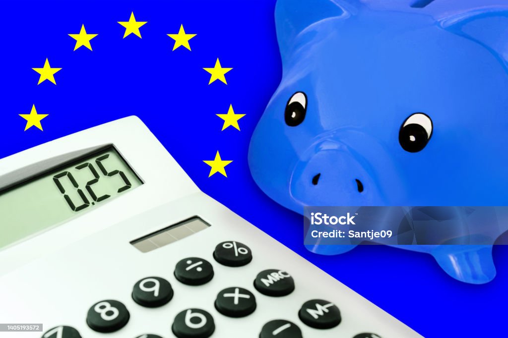 Blue piggy bank and calculator 0,25 with EU Flag 2022 Stock Photo