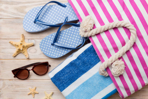 istock beach accessories flat lay top view on colored background Summer travel concept. Bag with starfish and sea shell. Top view 1405193842