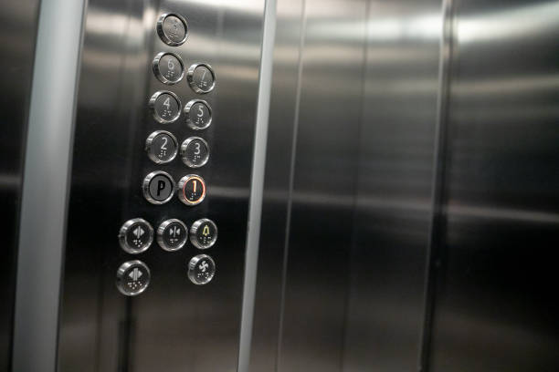 Floor buttons Elevator in an apartment residential building. Buttons of lift panel close-up. Movement, transportation concept. Lots of button on wall. Number on Elevators control panel is lit stock photo