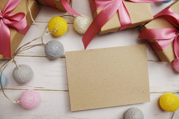 istock Empty Paper Craft with LED cotton balls and gift boxes on wooden background 1405201428