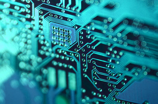 istock close-up of electronic printed board. Electronic board with blue light effects 1405207112