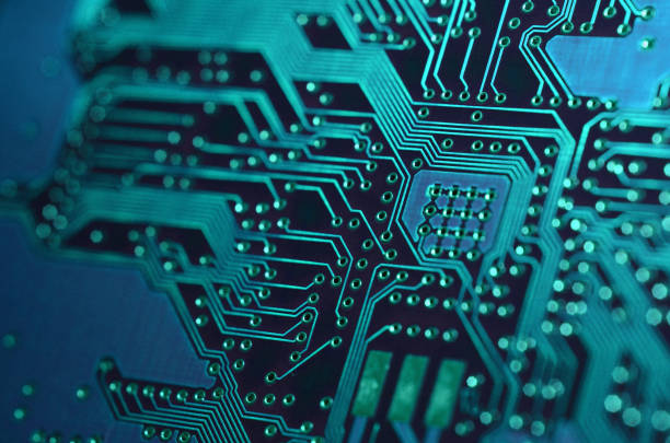 istock close-up of electronic printed board. Electronic board with blue light effects 1405207115