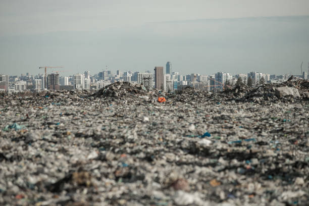 mountain of garbage on the background of the city stock photo