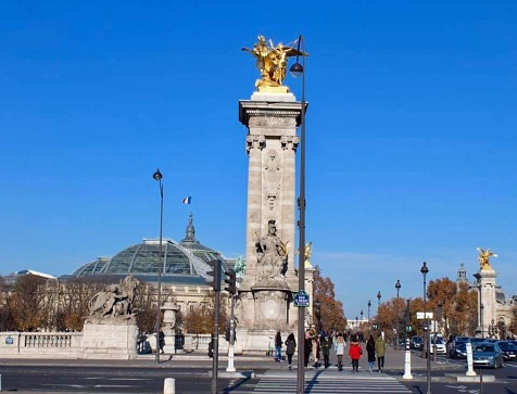 The Pont Alexandre III is a bridge, typical of the Beaux Arts style of the French Third Republic, that crosses the Seine River as it passes through Paris.