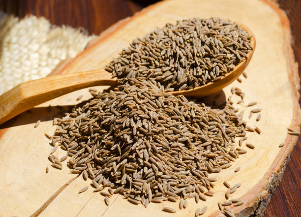 istock Cumin on a spoon on a wooden board. 1405209062