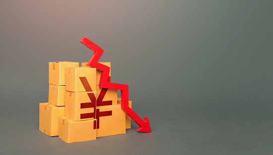 Boxes with yuan or yen symbol and down arrow. Fall in the production of goods. Worsening trade. Embargo, sanctions. Low consumption. Economic slowdown. Price reduction. Decrease in stocks of products.