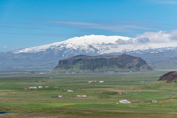 Panoramic view in southern Iceland with tuff mountain Petursey and Eyafjiallajokull volcano in the background stock photo