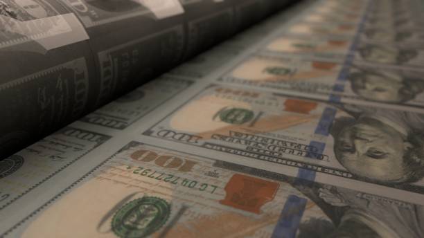 istock 100 dollar bills on money printing machine. 1405214563