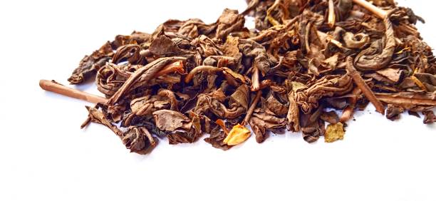 istock Roasted tea leaf on the white gray background. Camellia sinensis plant. 1405215812