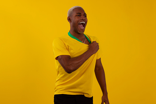Hombre brasileño de piel negra con camiseta del equipo de fútbol brasileño en foto de estudio photo