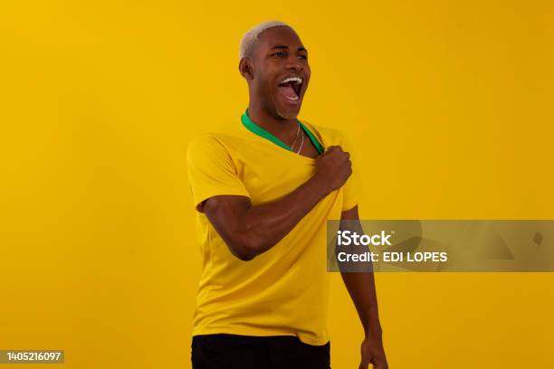 Blackskinned Brazilian Man With Brazilian Soccer Team Shirt In Studio Photo Stock Photo - Download Image Now