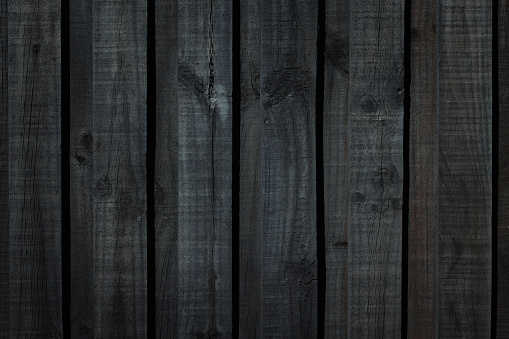 Old dark wooden fence detail.