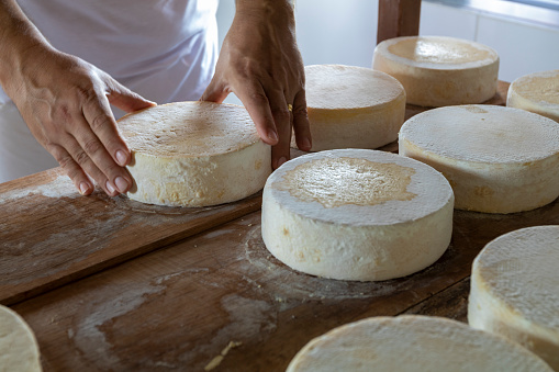 Cheese in hand on shop