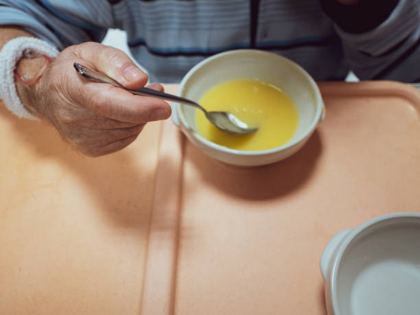 istock Older man eating pure in a hospital. 1405221041