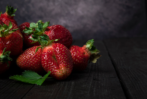 Healthy strawberries on wooden table. high resolution product. Harvest Concept