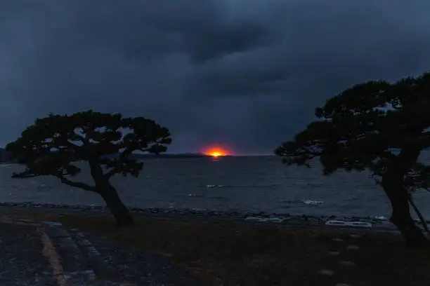 Photo of Sunset over Lake Shinji in mysterious mood in stormy winter day in Matsue, Japan