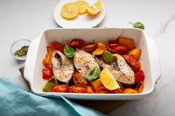 istock Roasted fish steak with vegetables heakthy food in white dish 1405225903