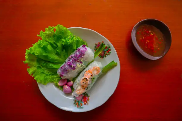 "Goi cuon is a traditional spring roll from Vietnam (Vietnamese food), made from meat, shrimp, vegetables, vermicelli, wrapped in rice paper or bánh tráng. served with sauce"