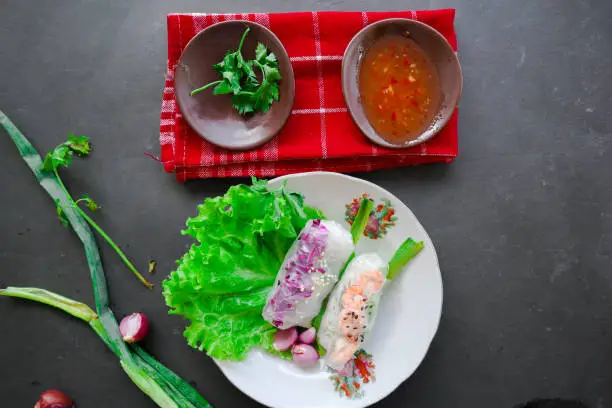 "Goi cuon is a traditional spring roll from Vietnam (Vietnamese food), made from meat, shrimp, vegetables, vermicelli, wrapped in rice paper or bánh tráng. served with sauce"