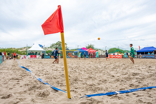Parnu, Estonia, Europe - June 19 2022: Boys playing beach soccer in summer on the sandy beach