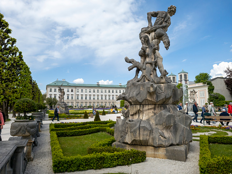 This image of Mirabell gardens in Salzburg, Austria, Europe includes a mythology-themed statue dating from 1730 , created by Italian sculptor Ottavio Mosto from 1690. The formal gardens also show the tree avenue at the entrance on the left.