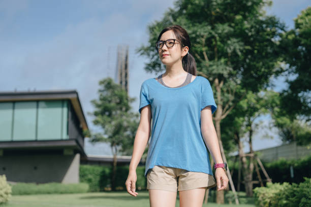 istock Young female athlete running in public park 1405231757