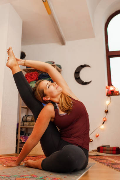 istock Young woman practicing yoga in the studio 1405234991
