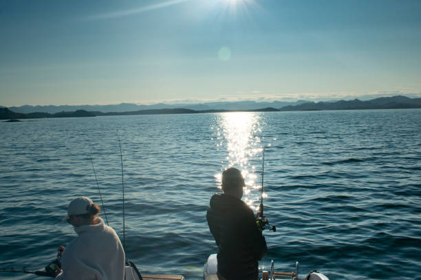 couple with fishing rod on a boat in the ocean near stavanger norway (jig fishing) - recreational boat nautical vessel fishing rod motorboat imagens e fotografias de stock