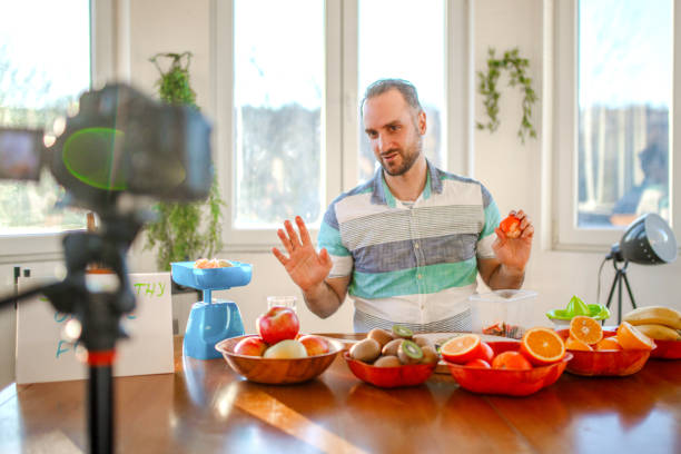 istock Young doctor making a video about importance of implementing fruit in everyday diet 1405239191