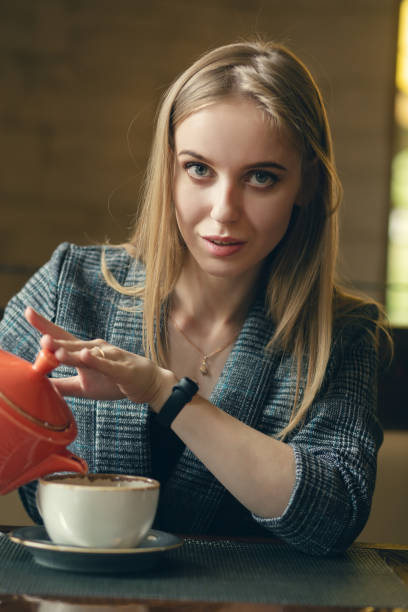 istock woman with teapot 1405239602