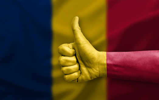 Hand making thumb up painted with flag of chad