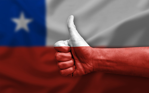 Hand making thumb up painted with flag of chile