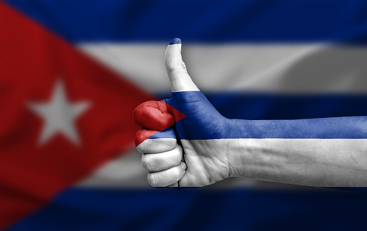 Hand making thumb up painted with flag of cuba