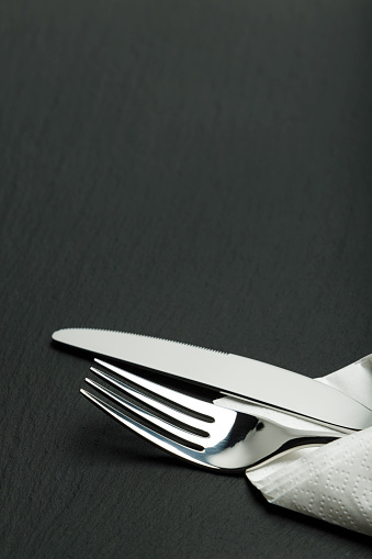 cutlery on a black slate