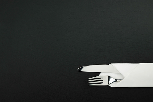 cutlery on a black slate