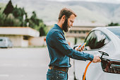 Man charging electric car