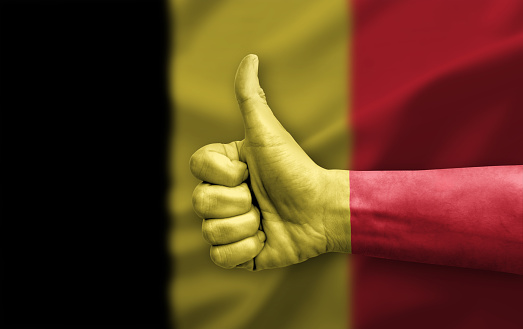 Hand making thumb up painted with flag of belgium