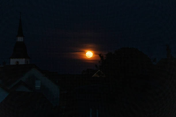 Kichen silhouette with full moon Full moon behind clouds with silhouette of the village red full moon stock pictures, royalty-free photos & images
