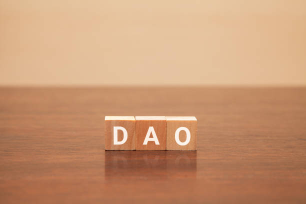 istock DAO characters. Decentralized autonomous organization. Written on three wooden blocks. White letters. 1405245618