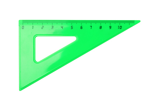 Green plastic ruler triangle isolated on white. Top view.