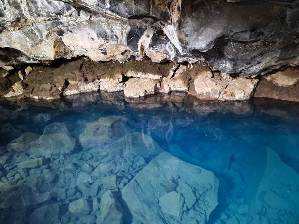 istock View into Grjotagja lava cave with crystal clear blue water. 1405245684